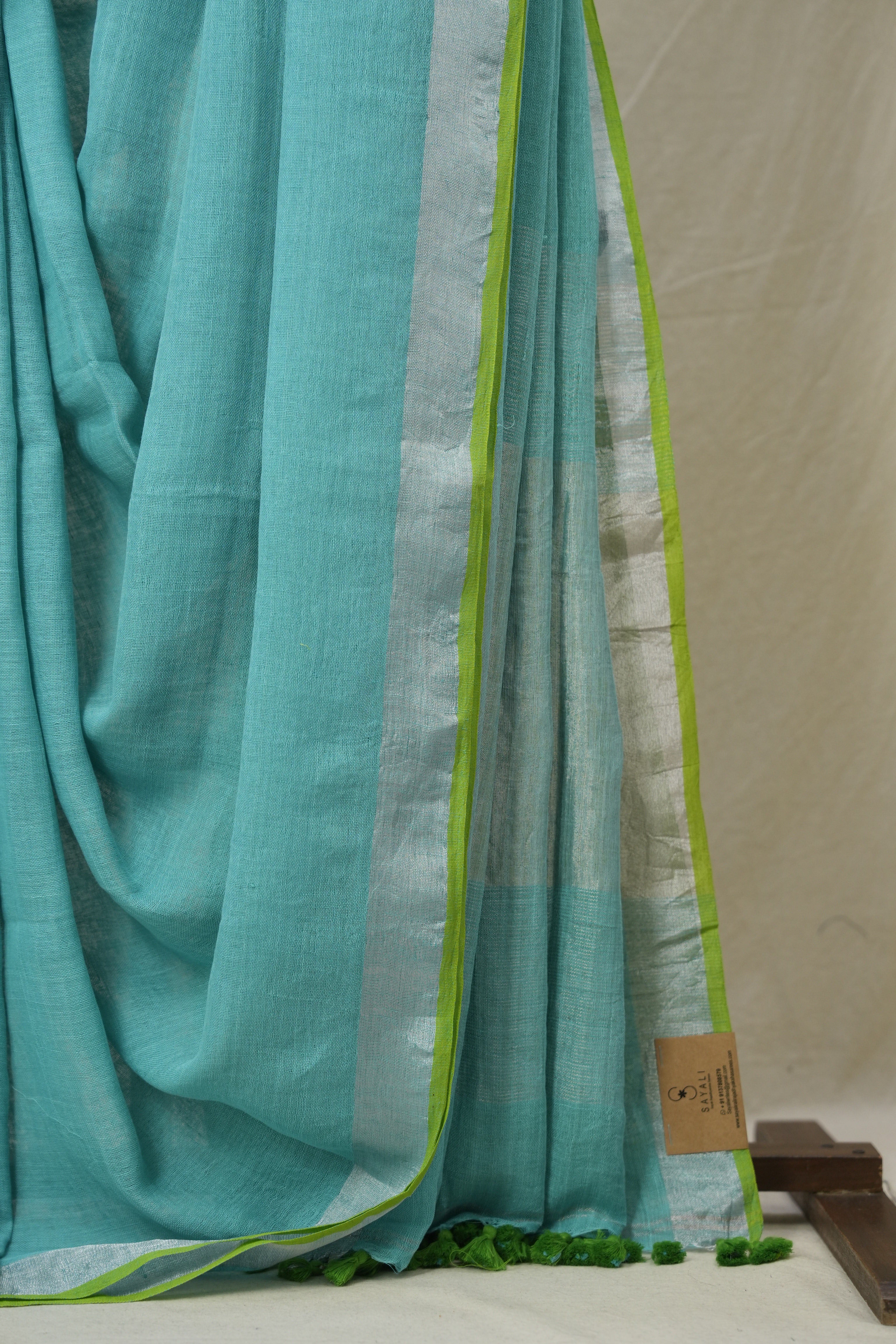 Aqua Plain Linen Saree With Parrot Green Tassels - SRAPLSWPGT344